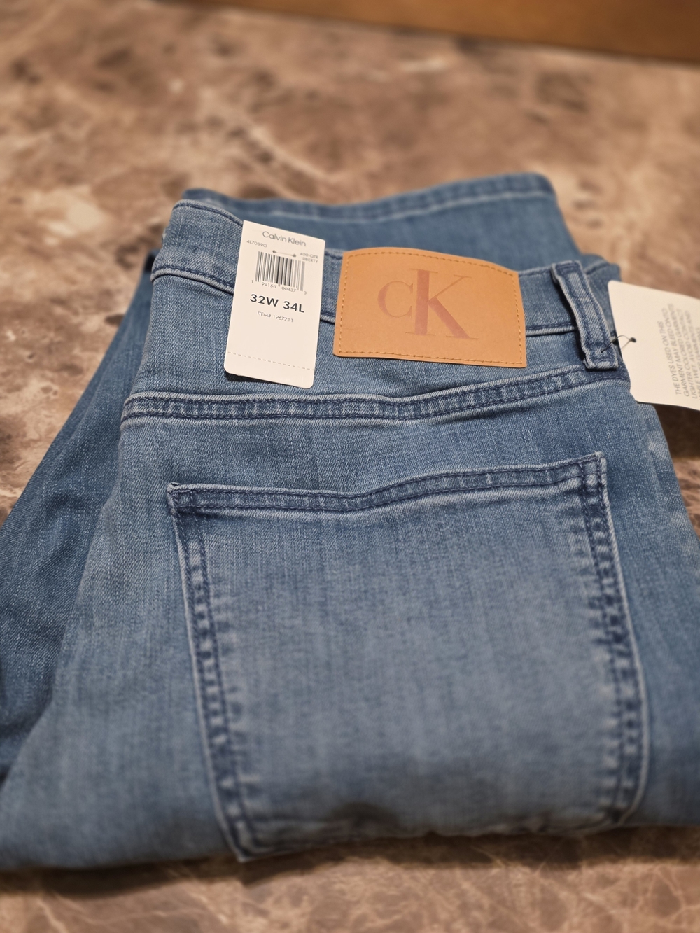 Calvin Klein Men's Straight Jeans in Light Blue Denim with Tan Patch